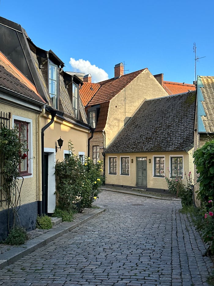 charming-cobblestone-street-in-lund-sweden-29999249 Historical houses on the street in the old town Lund, Skåne County, Sweden, August 2023