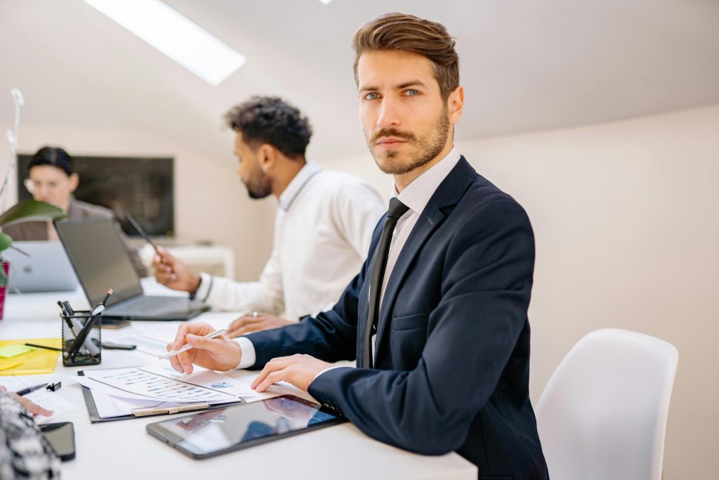 pexels-photo-7693715-7693715 Confident businessman working with a team in a modern office, teamwork and collaboration vibe.